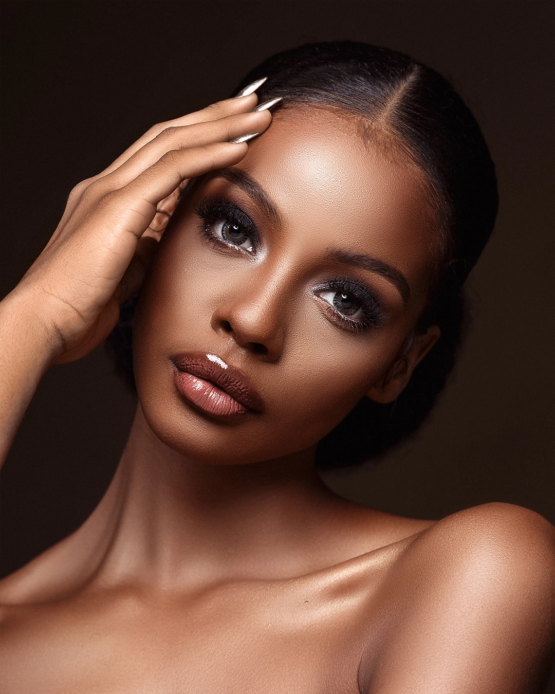 Close-up portrait with even skin, natural glow, and soft shadows